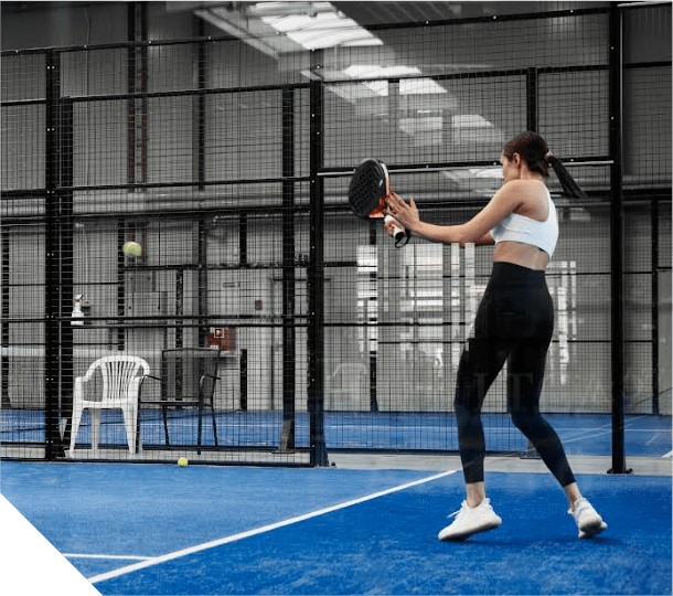 Player hitting a padel shot on an indoor court at Cube Chicago Padel in Chicago